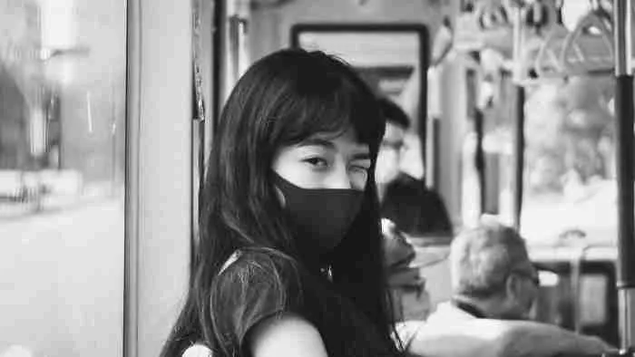 person with a covid mask on public transit
