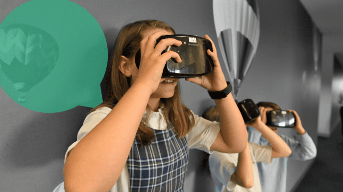 Three school children with a VR set